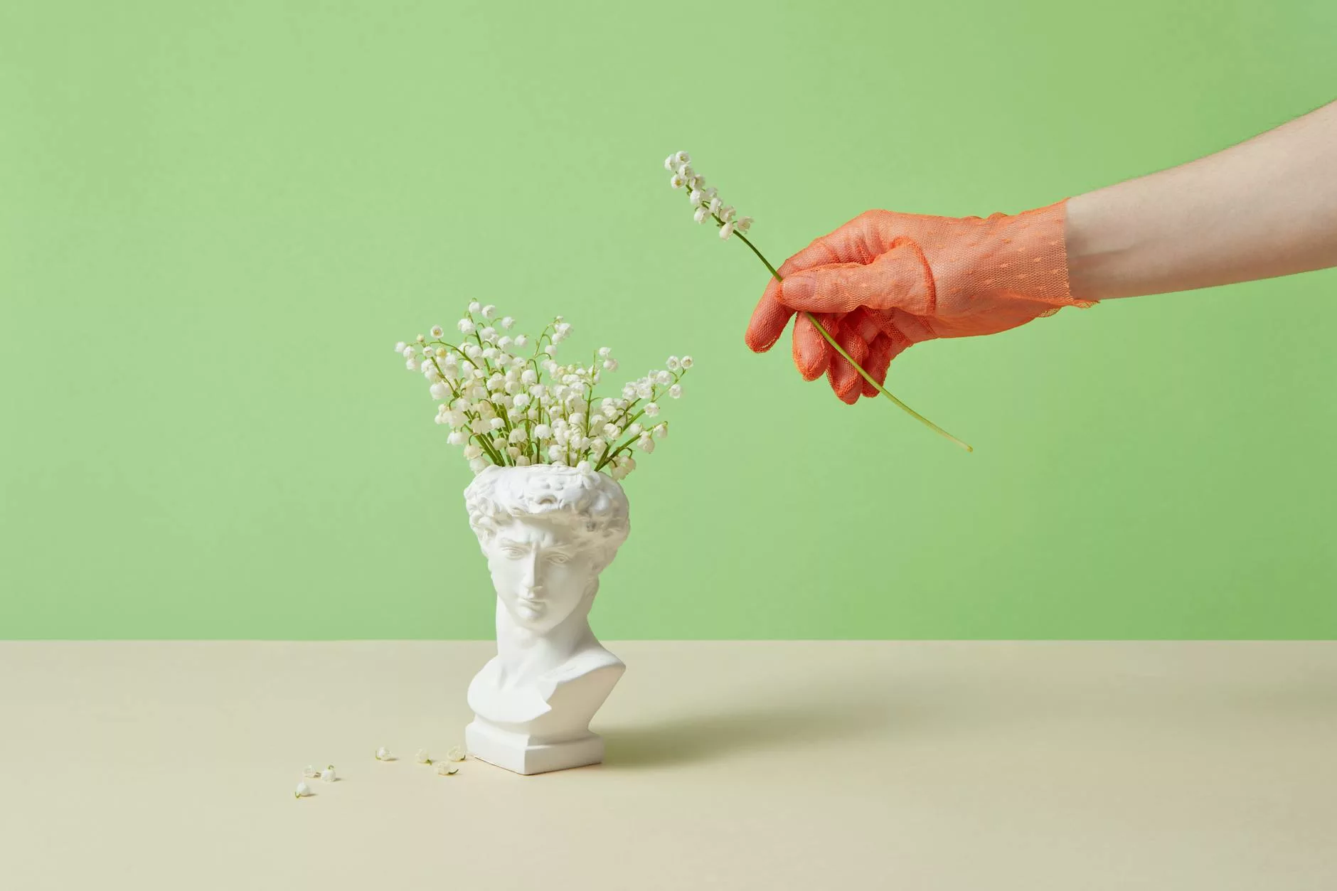 a sculpture of a head as a flower vase